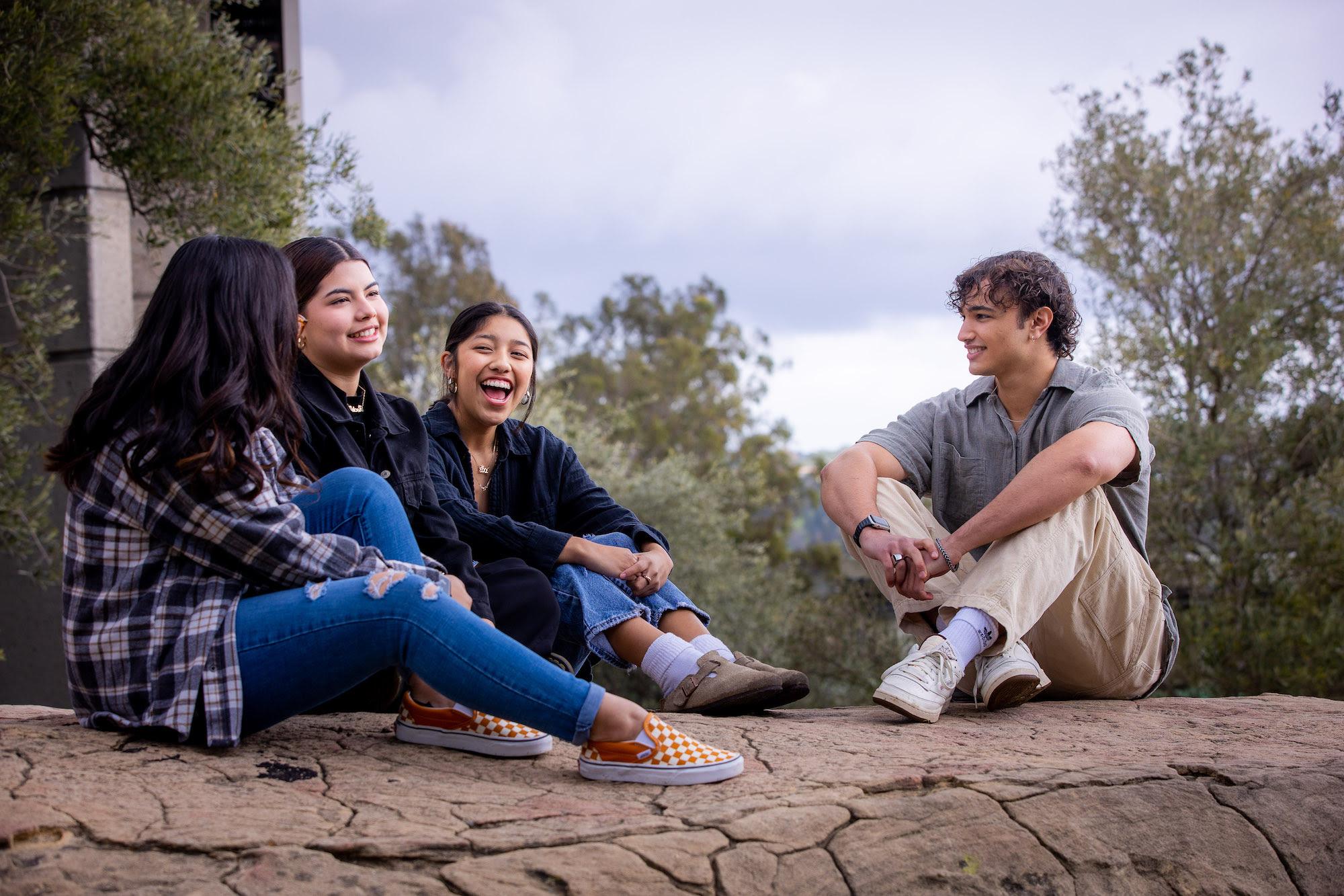 westmont students sitting on the rock